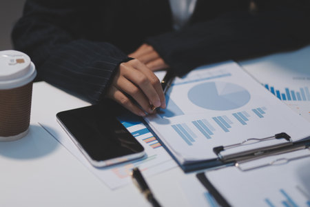 Close up of Business team analyzing income charts and graphs with modern laptop computer. Business analysis and strategy concept.の写真素材
