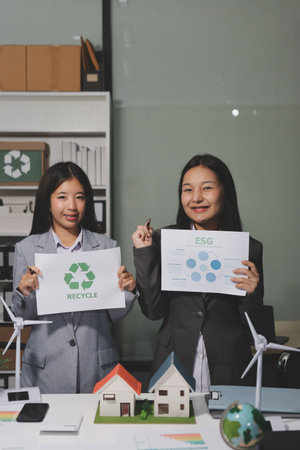 Business team people planning and discussing on recycle reduce reuse policy symbol in office meeting room.の写真素材