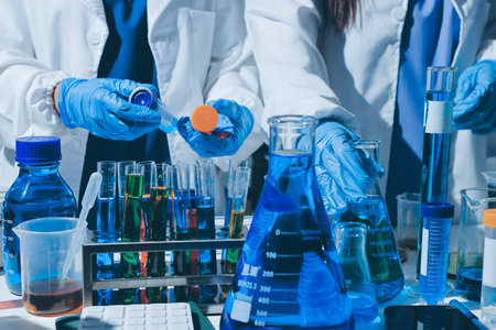 Scientist pipetting medical samples into microplate in laboratory