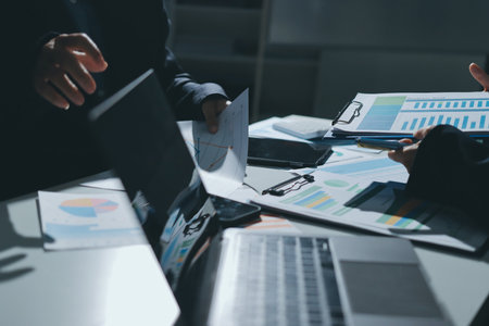 Group of business women working on a financial data expenses document.