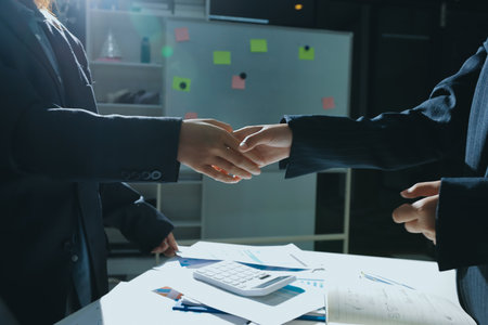Happy two Asian business man and woman handshake to congratulate success. Successful Asian business...