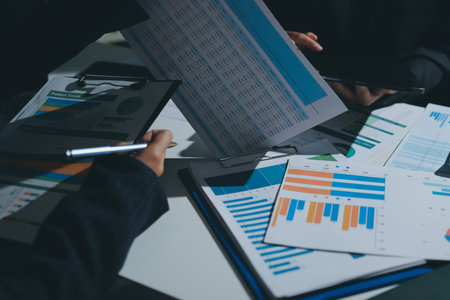 Group of business women working on a financial data expenses document.