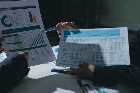 Group of business women working on a financial data expenses document.