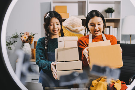 Portrait of Starting small businesses SME owners, two Asian woman check online orders Selling...