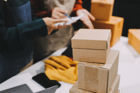 Portrait of Starting small businesses SME owners, two Asian woman check online orders Selling...
