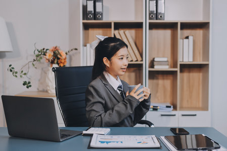 Asian Businesswoman Using laptop computer and working at office with calculator document on desk,...