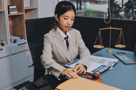 Judge gavel with Justice lawyers having team meeting at law firm background. Concepts of Law and Legal services.の写真素材