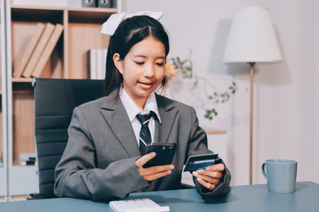 Close up woman hand using credit card and smartphone laptop for buying online shopping