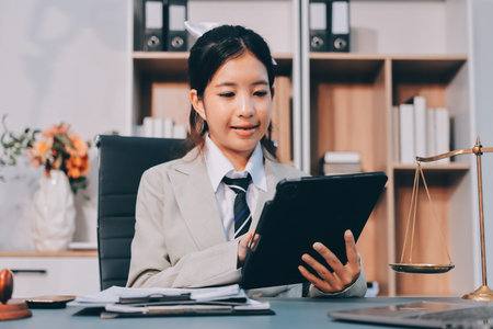 Judge gavel with Justice lawyers having team meeting at law firm background. Concepts of Law and Legal services.の写真素材