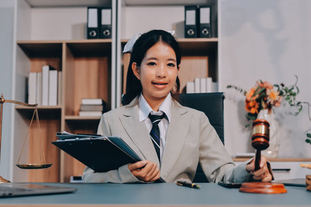 Judge gavel with Justice lawyers having team meeting at law firm background. Concepts of Law and Legal services.の写真素材