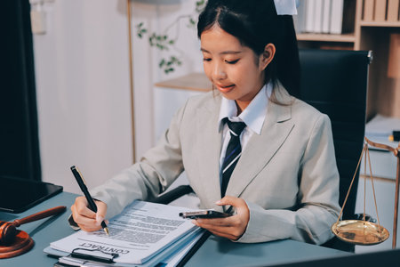 Judge gavel with Justice lawyers having team meeting at law firm background. Concepts of Law and Legal services.の写真素材