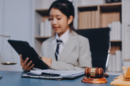 Judge gavel with Justice lawyers having team meeting at law firm background. Concepts of Law and...