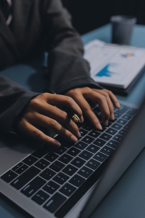 Close up of business woman hands typing on laptop computer and digital tablet, searching and surfing...