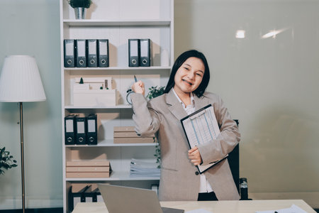 Entrepreneur Asian businessman and businesswoman discussing new business project in tablet in modern...