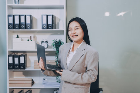 Entrepreneur Asian businessman and businesswoman discussing new business project in tablet in modern...