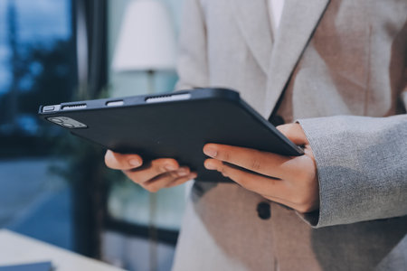 Entrepreneur Asian businessman and businesswoman discussing new business project in tablet in modern...