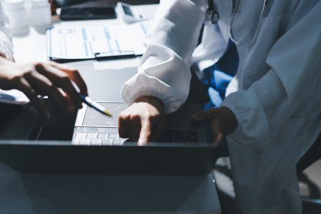 Male and female doctors are having a meeting in a hospital room.