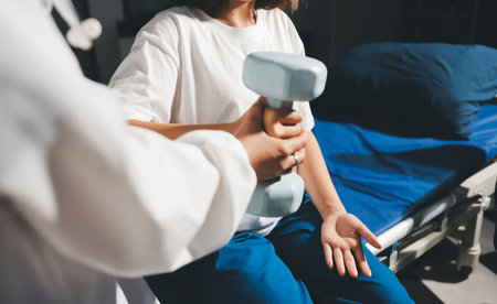 Unrecognizable uses blue hand weight during physical therapy session