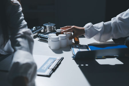 Male and female doctors are having a meeting in a hospital room.