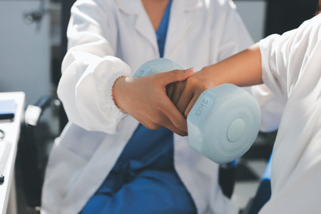 Unrecognizable uses blue hand weight during physical therapy session