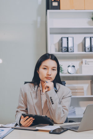 Businesswoman discussing new business project in tablet in modern office.の写真素材