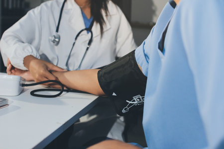 Doctor checking patient arterial blood pressure in hospital. Health care Concept
