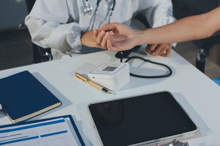 Doctor checking patient arterial blood pressure in hospital. Health care Concept