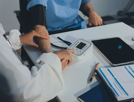 Doctor checking patient arterial blood pressure in hospital. Health care Concept