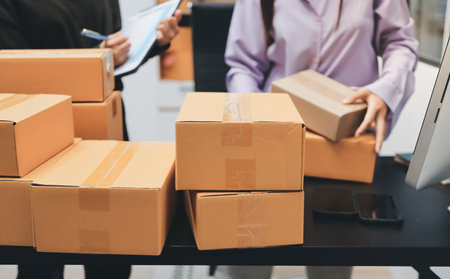 Portrait of Starting small businesses SME owners, two Asian woman check online orders Selling...