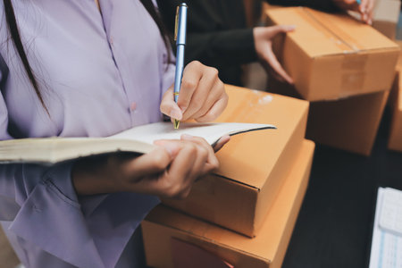 Portrait of Starting small businesses SME owners, two Asian woman check online orders Selling...