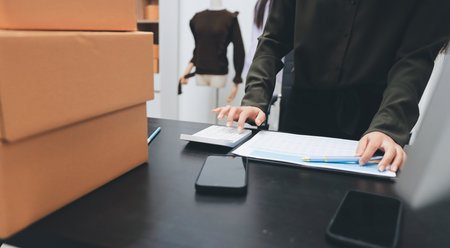 Portrait of Starting small businesses SME owners, two Asian woman check online orders Selling...