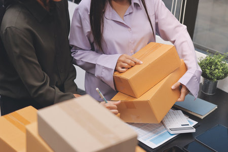 Portrait of Starting small businesses SME owners, two Asian woman check online orders Selling...