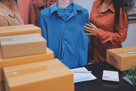 Portrait of Starting small businesses SME owners, two Asian woman check online orders Selling products working with boxs freelance work at home office, sme business online small medium enterpriseの写真素材