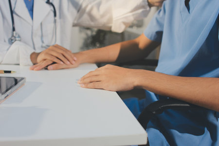 Doctor came to check the patient and shook his hand to encourage. Comforting the sick and treating the best, cured in the hospital.の写真素材