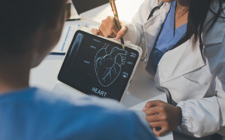 Cropped shot of an unrecognisable doctor sitting with his patient and showing her x-rays on a digital tabletの写真素材