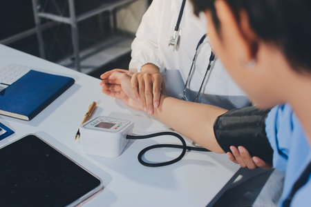 Doctor checking patient arterial blood pressure in hospital. Health care Conceptの写真素材