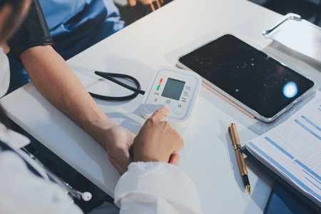 Doctor checking patient arterial blood pressure in hospital. Health care Conceptの写真素材
