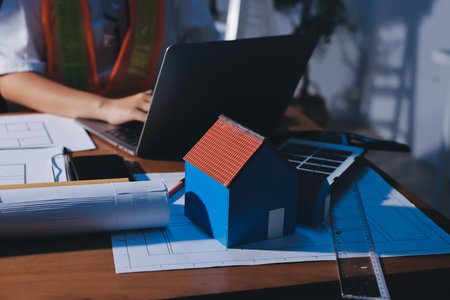 Closeup of team of industrial engineers meeting analyze machinery blueprints consult project on table in manufacturing factory. Working in manufacturing plant or production plant.の写真素材