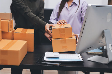 Portrait of Starting small businesses SME owners, two Asian woman check online orders Selling...