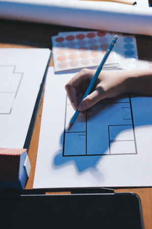 Closeup of team of engineers meeting analyze blueprints consult project on table. Working in manufacturing plant or production plant.の写真素材
