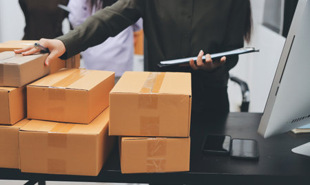 Portrait of Starting small businesses SME owners, two Asian woman check online orders Selling...