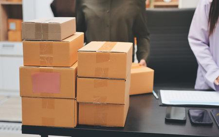 Portrait of Starting small businesses SME owners, two Asian woman check online orders Selling...
