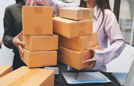 Portrait of Starting small businesses SME owners, two Asian woman check online orders Selling...