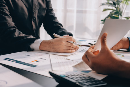 Accounting company provide finance and taxation planning for profitable cash flow, Auditor and accountant team working in office, analyze financial data and accounting record with calculator.Insightの写真素材