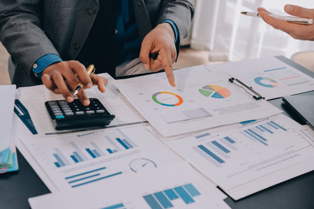 Accounting company provide finance and taxation planning for profitable cash flow, Auditor and accountant team working in office, analyze financial data and accounting record with calculator.Insightの写真素材
