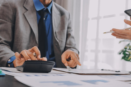 Accounting company provide finance and taxation planning for profitable cash flow, Auditor and accountant team working in office, analyze financial data and accounting record with calculator.Insightの写真素材