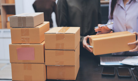 Portrait of Starting small businesses SME owners, two Asian woman check online orders Selling...