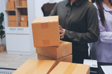 Portrait of Starting small businesses SME owners, two Asian woman check online orders Selling...