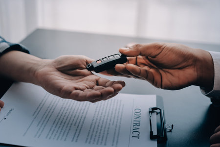 Car salesman gave the keys to the customers who signed the purchase contract legally, Successful completion of car sales, Purchase contract and key delivery.の写真素材