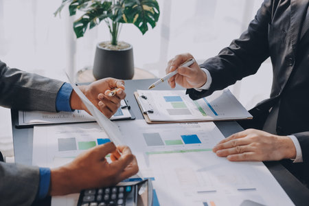 Accounting company provide finance and taxation planning for profitable cash flow, Auditor and accountant team working in office, analyze financial data and accounting record with calculator.Insightの写真素材